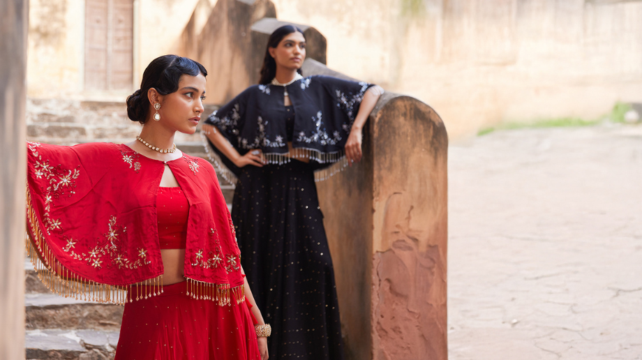 Women styled in contemporary ethnic wear with embroidered capes