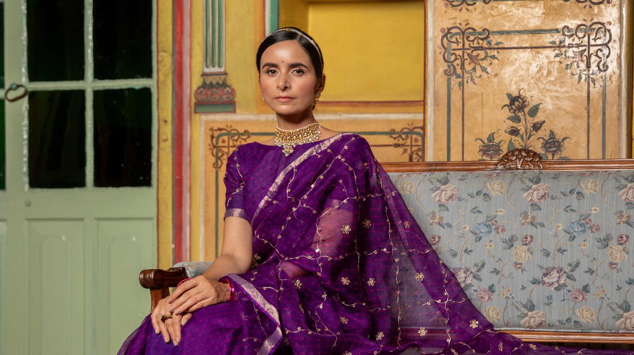 Classic ethnic look in a deep purple saree with gold accents